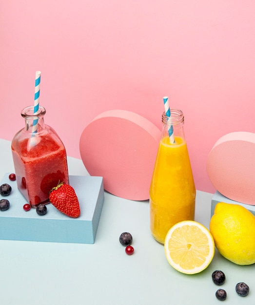 Photo jars with healthy smoothie on geometric support