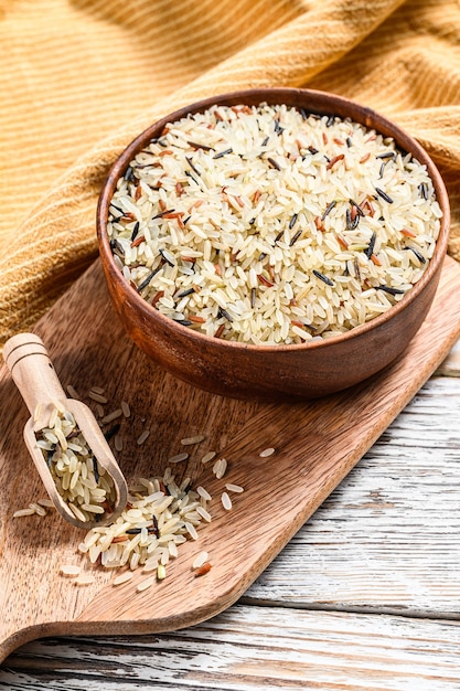 Jasmine, Brown, Red and  Black rice in a bowl. Mixed rice and Riceberry. White background. Top view.