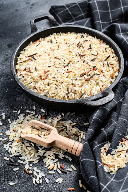 Jasmine, brown, red and black rice. mixed rice and riceberry.\
black background. top view