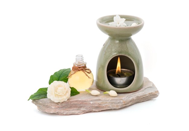 Jasmine flower , essential oil and oil burner isolated on white\
with clipping path.