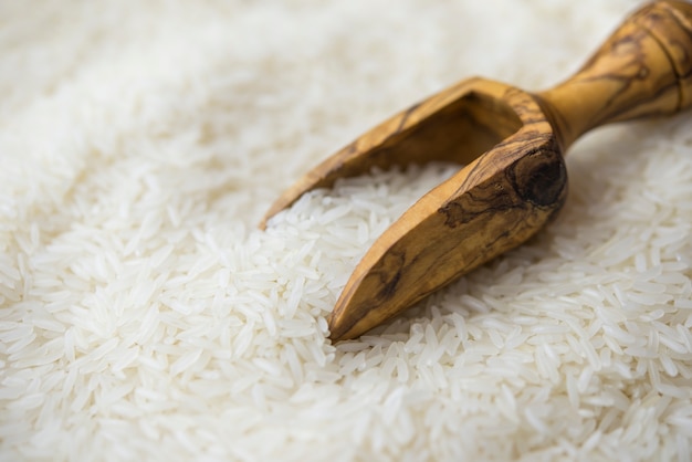 Jasmine rice in a wooden scoop