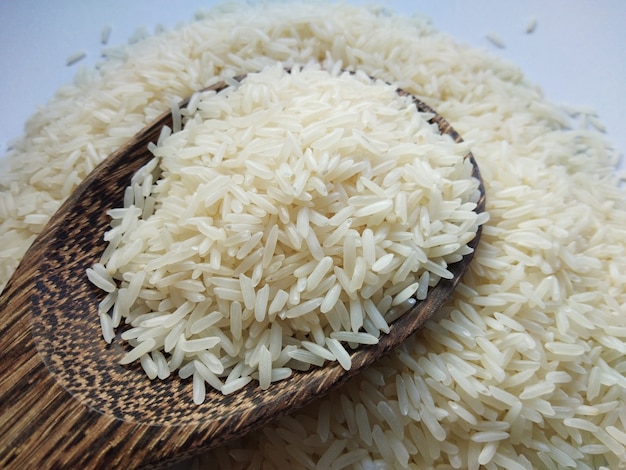 Jasmine rice on wooden spoon top view