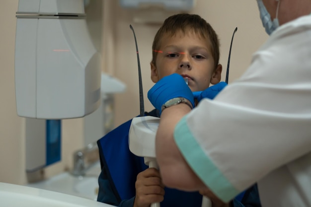 Jaw computed tomography check up teeth in dental clinic Boy in vest on xray diagnostics Circular snapshot of jaw