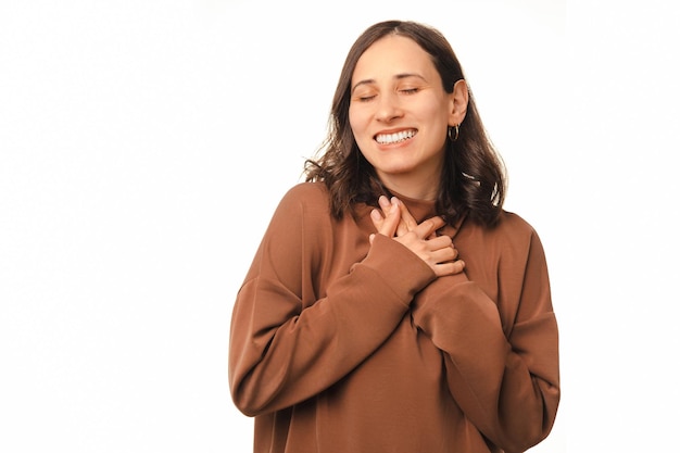 Je bent zo dierbaar voor mijn hart, denkt een vrouw terwijl ze haar hand op haar borst houdt