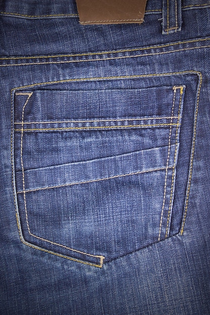 Jeans achterzak. Detailopname. Mode jeans knop. Kleding label.