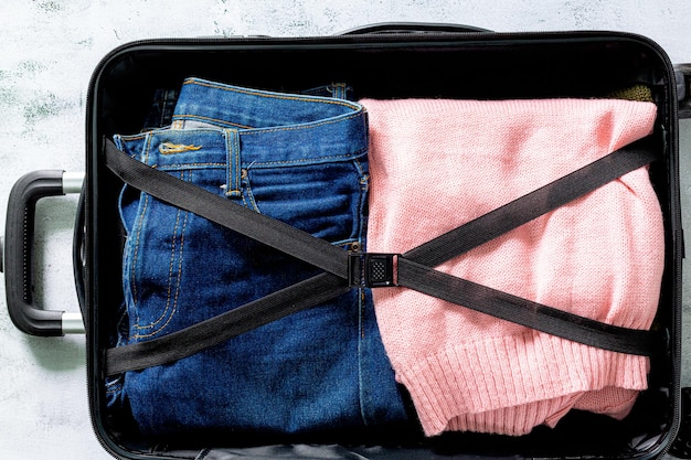 Jeans and clothes in luggage,jeans in suitcase top view,packing
suitcases. shot of clothes and jeans