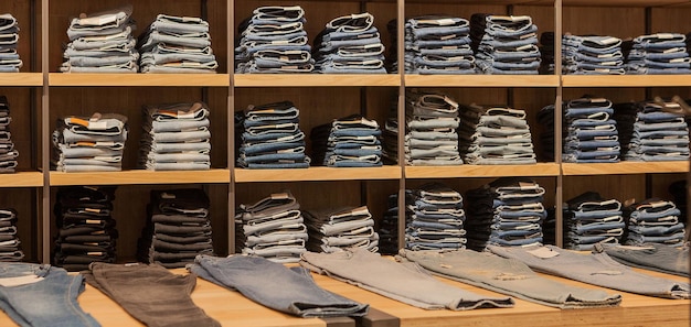 Jeans pants on the store shelf Blue jeans denim Collection jeans stacked