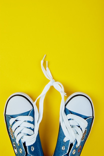 jeans sneakers on yellow