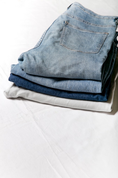 jeans stacked on a white background