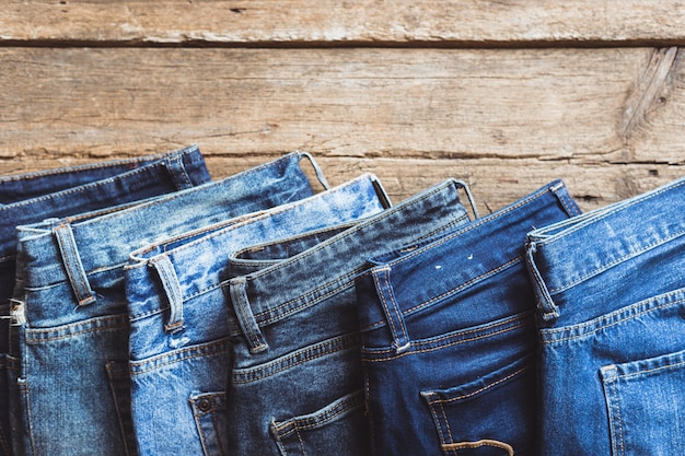 Jeans stacked on a wooden background