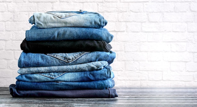 Jeans trousers stack with a place for an inscription Concept jeans in supermarket and shop Background with copy space