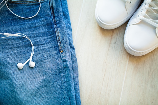 Jeans and white sneakers on the shelf