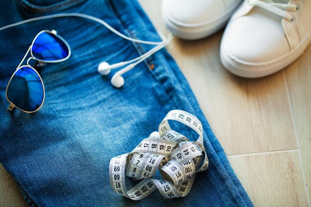 Jeans and white sneakers on the store shelf.