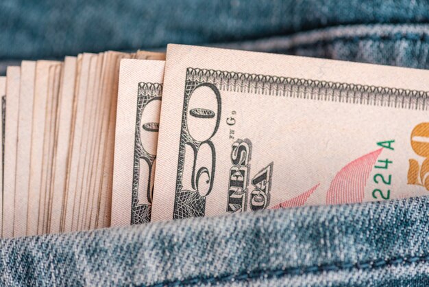 jeans with US dollar bills in a pocket. Dollars in jeans. Financial concept.