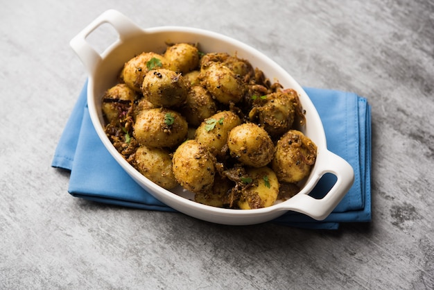 Jeera Aloo - Potatoes Flavoured With Cumin seeds and spices. popular Indian main course recipe. served in a bowl. selective focus