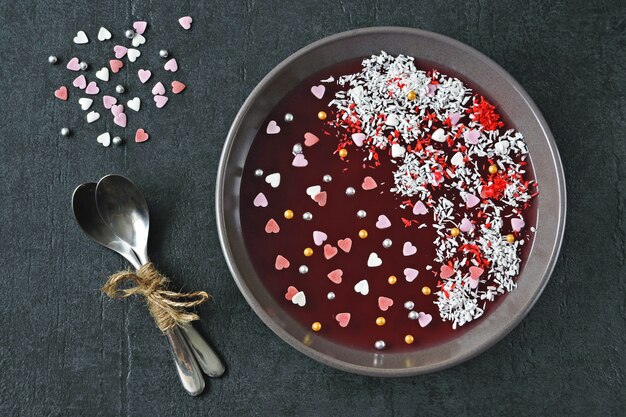 Jelly Bowl for Valentine's Day. Beautiful plate with marmalade and Valentine's day decorations. Dessert on Valentine's Day.