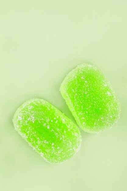 Jelly candies on green background