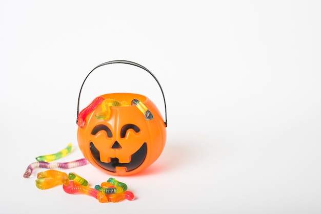 Photo jelly candies near jack-o-lantern basket