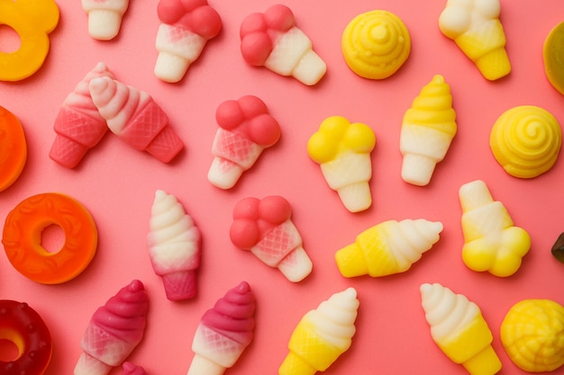 Jelly candies on pink background top view