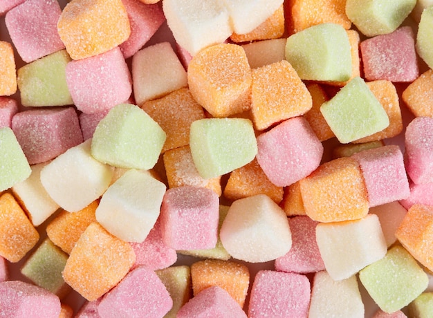 Jelly chewing colorful sweets in sugar as a background Top view