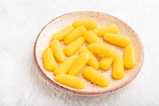 Jelly corn candies on gray concrete background