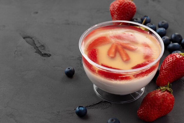 Jelly dessert with strawberry in a glass cup 