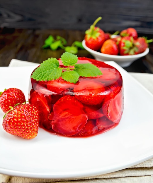 Jelly strawberry with mint and berries on dark board