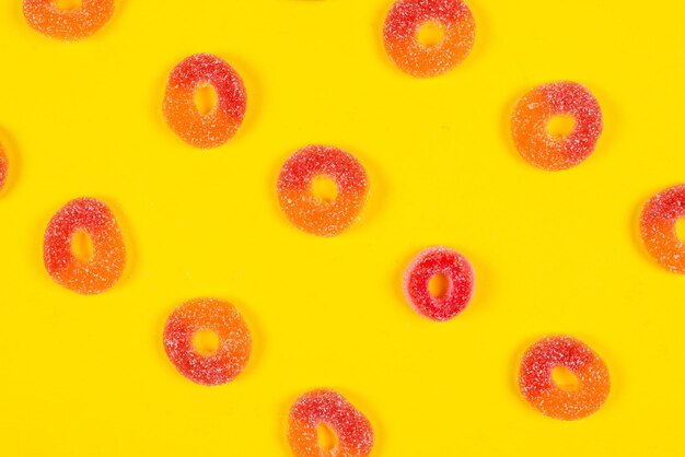 Jelly sweets rings on yellow background Pattern