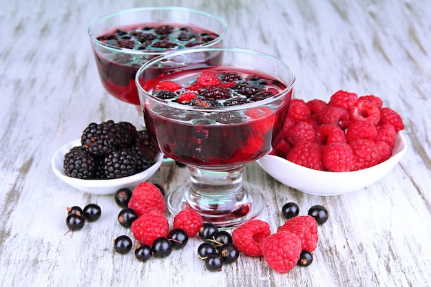 Jelly with fresh berries on wooden table close up