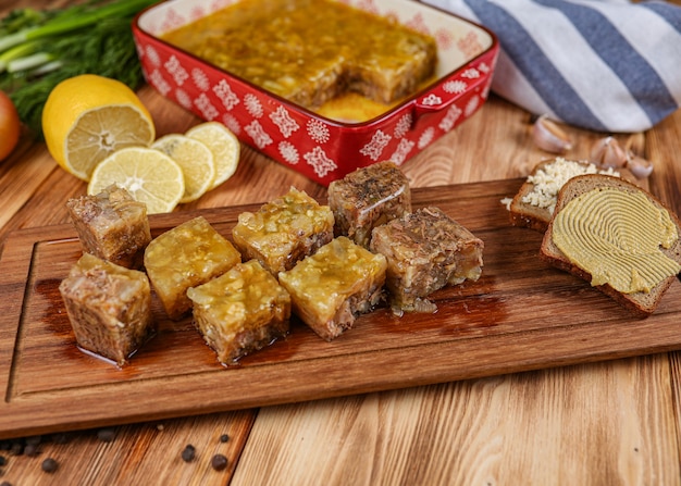 Jelly with meat, beef aspic, traditional Russian dish, portion on a plate, mustard and horseradish