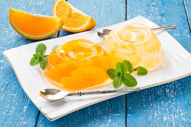 Jelly with slices of citrus and pineapple on a plate