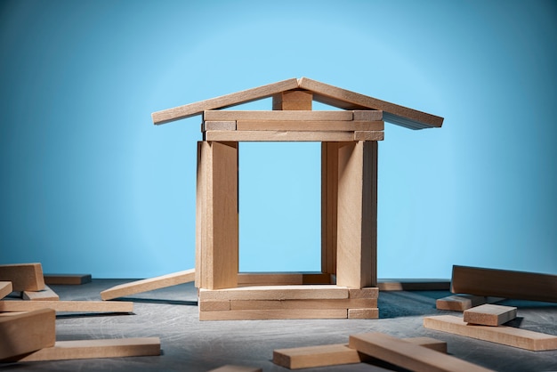 Jenga game, a house made of wooden blocks on blue