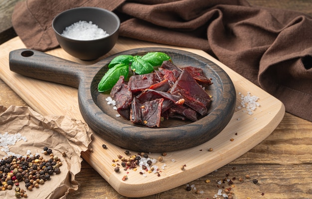 Photo jerky meat in a wooden plate.