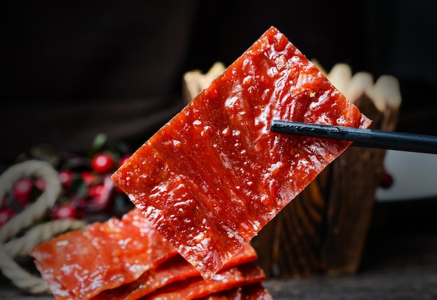 Jerky salami with sauce on wooden board