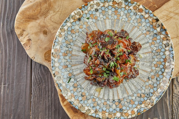 Jerusalem artichoke with shallots and herbs fried in pan. Flat lay