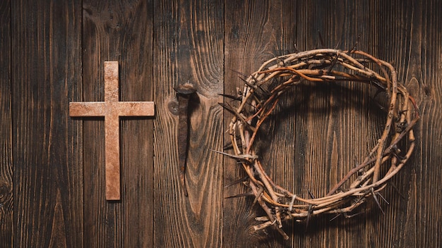 Jesus crown thorns and nails and cross on a wood background easter day