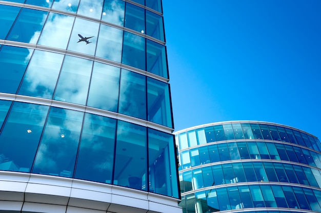 A jet airplane silhouette with business office towers background, London