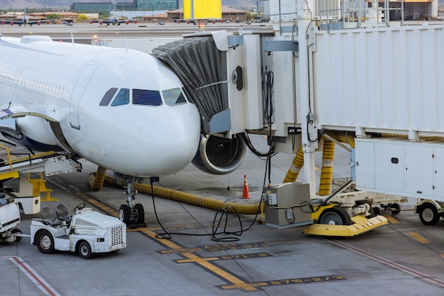 Jet engine against a middle size plane at the airport on loading aircraft at the International Airport