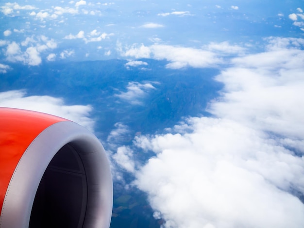 Jet engine of red airplane from window of passenger view