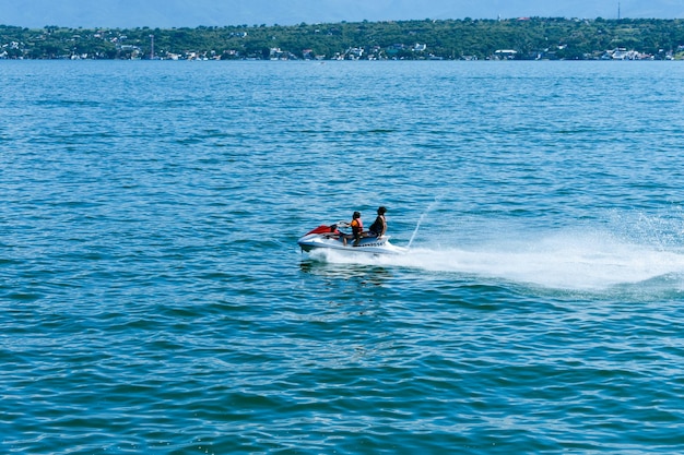 A jet ski is in the water with a city in the background