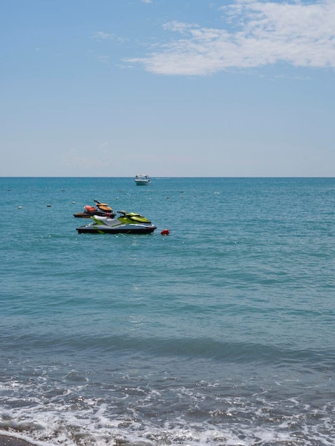 Jet skis moored at sea