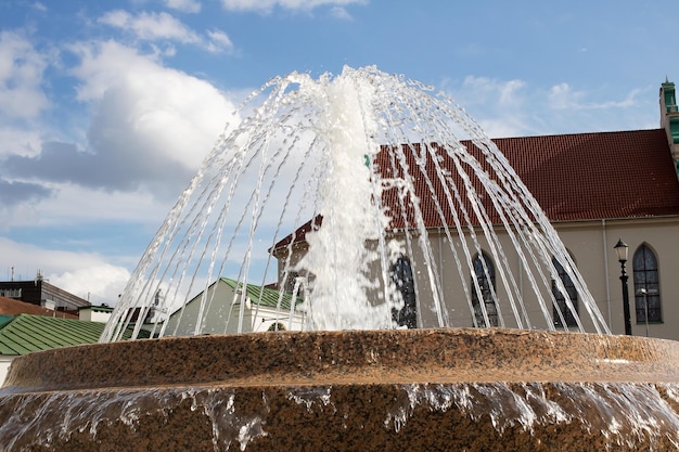 Jet of water in the fountain green dirty water