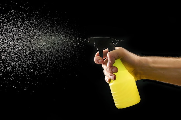 A jet of water shoots from a spray bottle