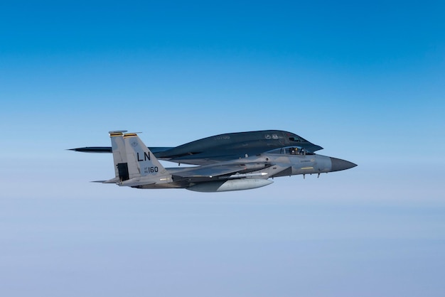 A jet with the letters f - 15 on it flies through the sky.