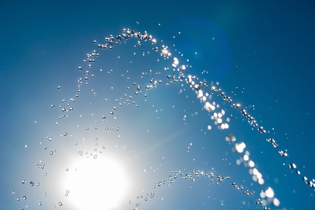 Jets of a fountain Splashing water on a sunny day against the sky