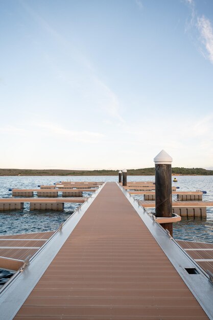 Jetty with a forest in the background during the sunset