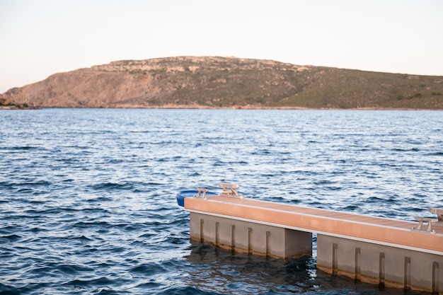 Jetty with a mountain in the background during the sunset