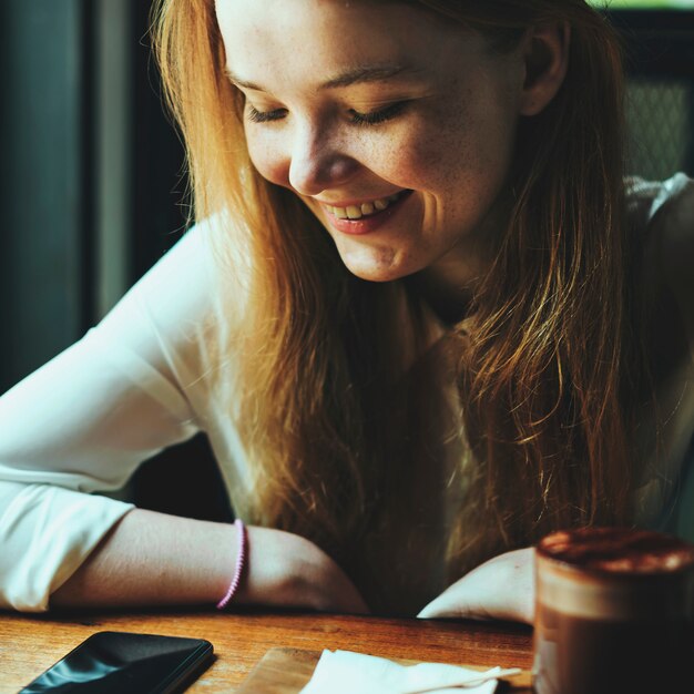 Foto jeugd vrouw koffie winkel met behulp van slimme telefoon concept