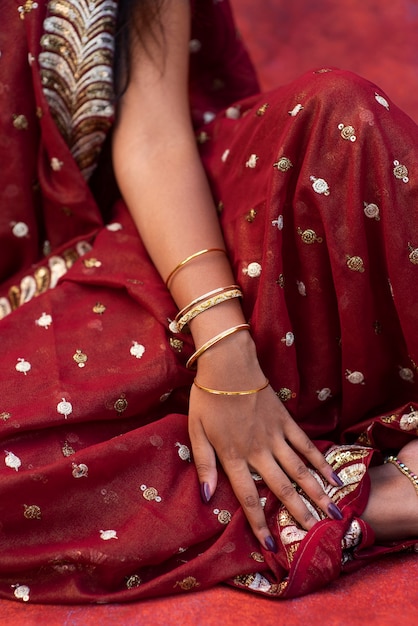 Jewel details on hands of woman wearing a sari dress