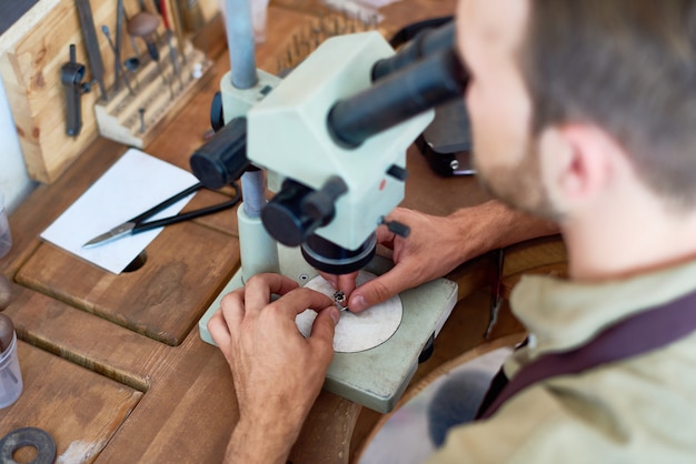 Jeweler Inspecting Precious Stone